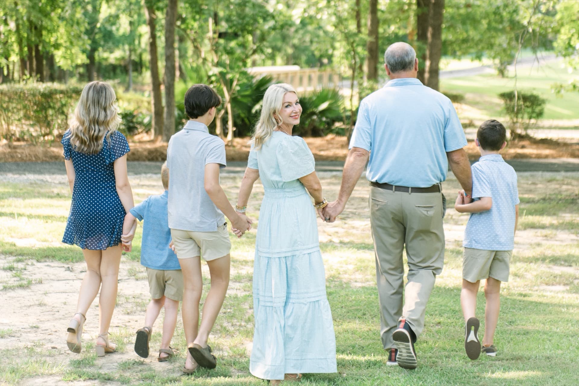 Keri H. Carroll walking hand in hand with her husband Luke and their four children